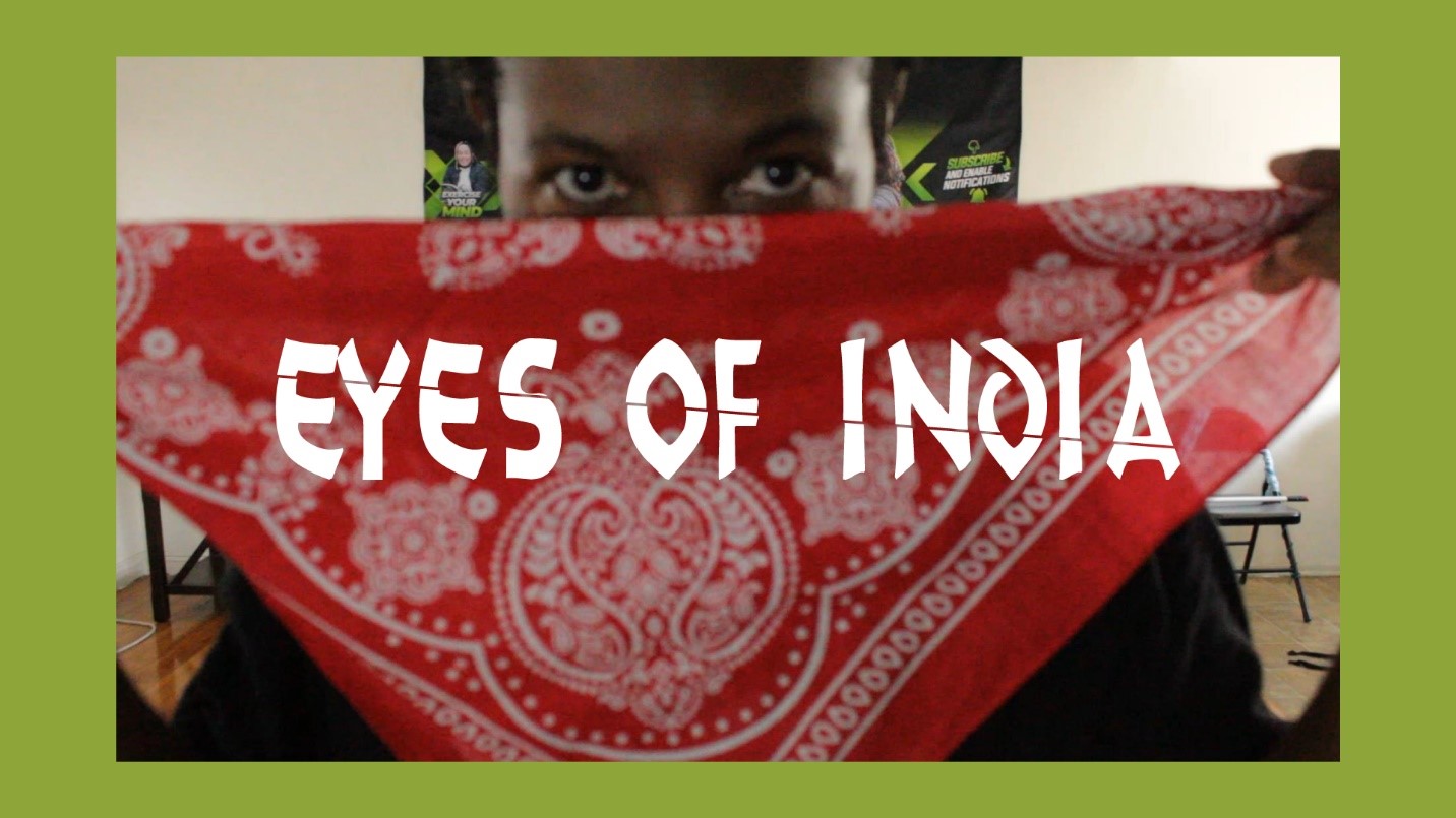 A person holding a handkerchief with “eyes of India” written on it